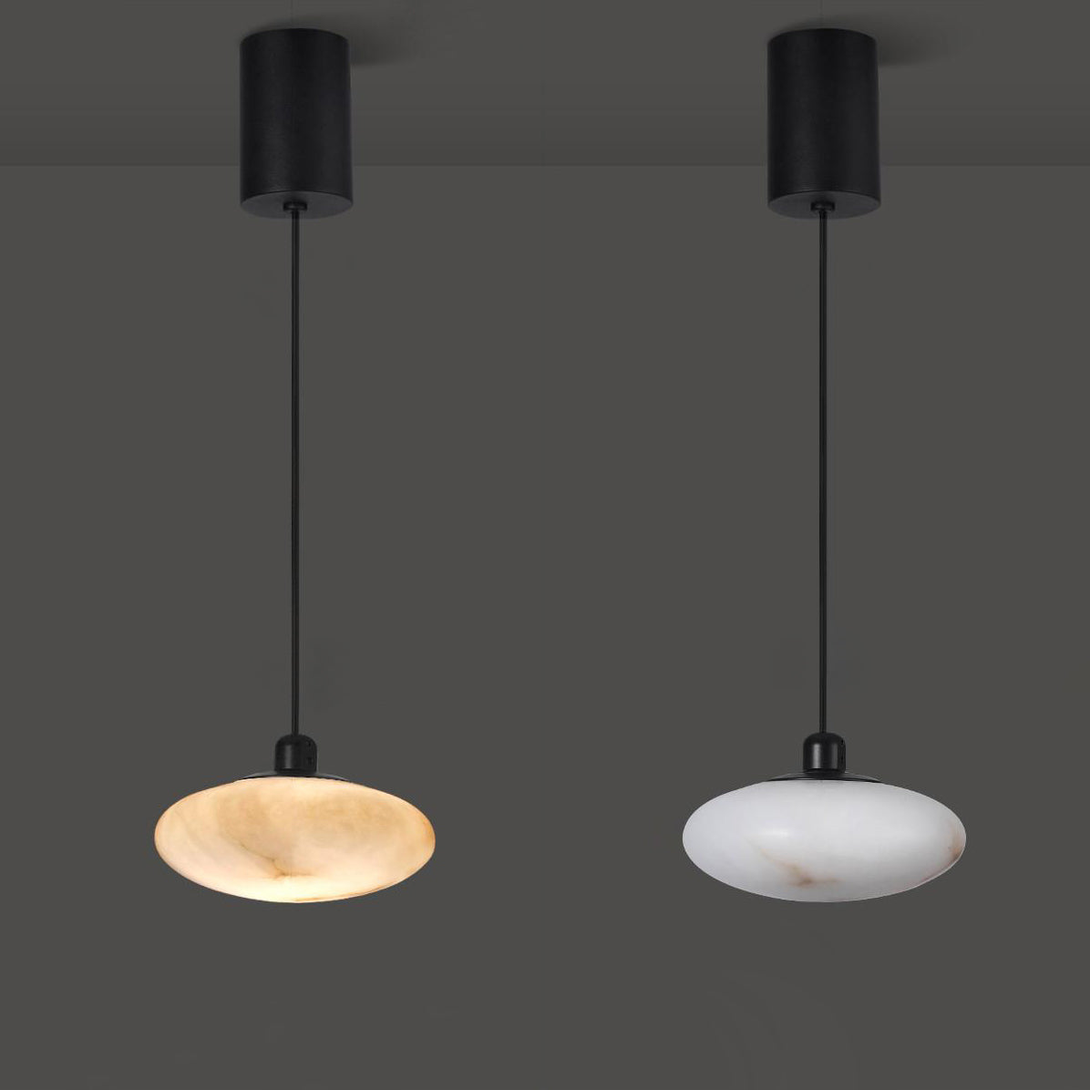 Two Clérachic Mini Discus pendant lights side by side, one lit to amber and one unlit and chalky white, for comparison.