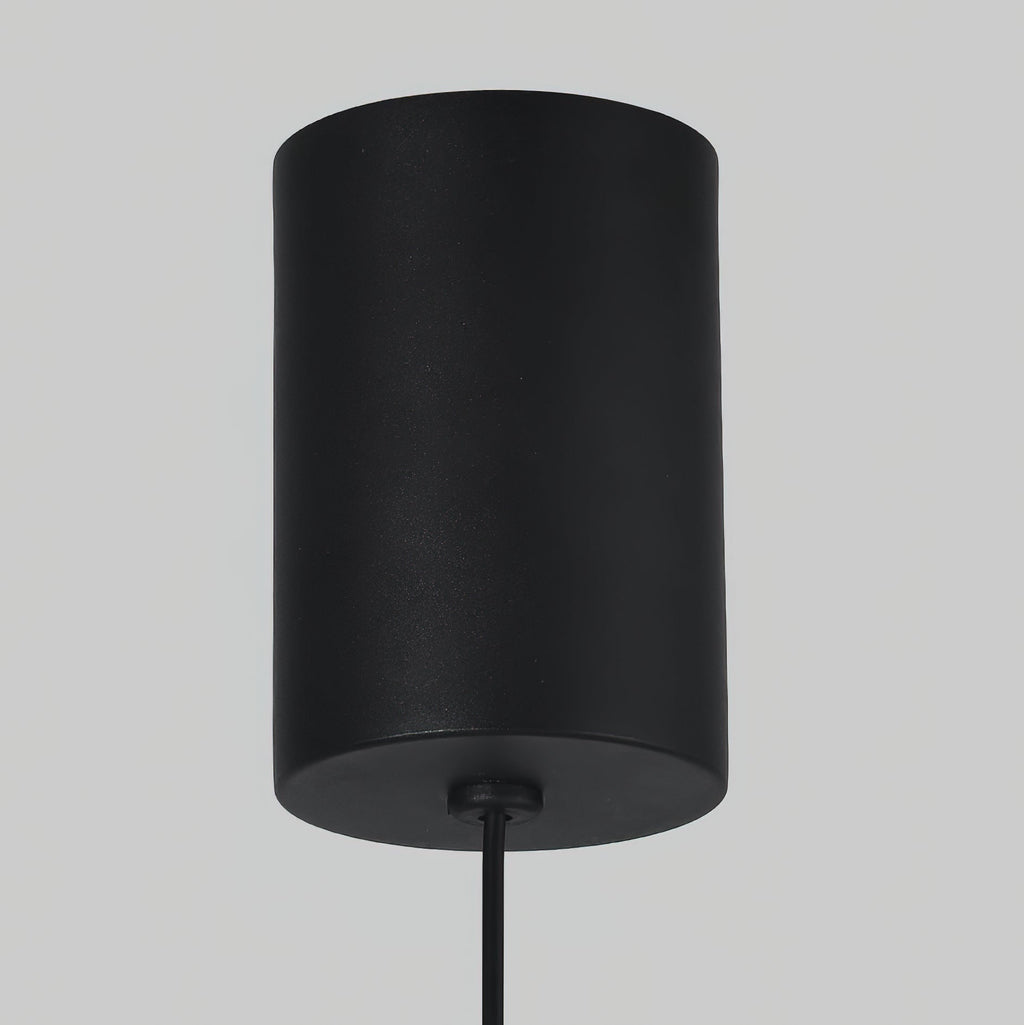 Detail of the matte black cylindrical ceiling mount on the Clérachic Mini Discus pendant light, with its round cord.