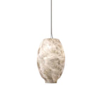The Clérachic alabaster pendant in a warmer-toned stone, oval shade suspended on a fine cable.