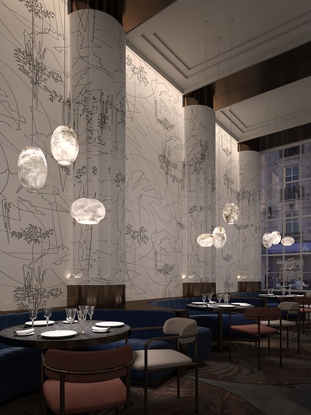 Clérachic alabaster pendants hung through a restaurant interior with blue banquette seating.