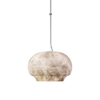 The Clérachic alabaster pendant on white, full drop from cable to the low domed stone shade.
