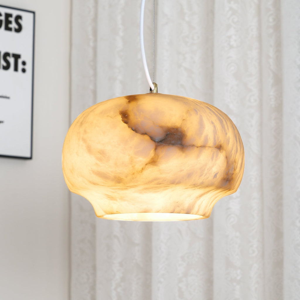 Macro of the Clérachic alabaster shade lit from within, amber tones flooding the stone grain.