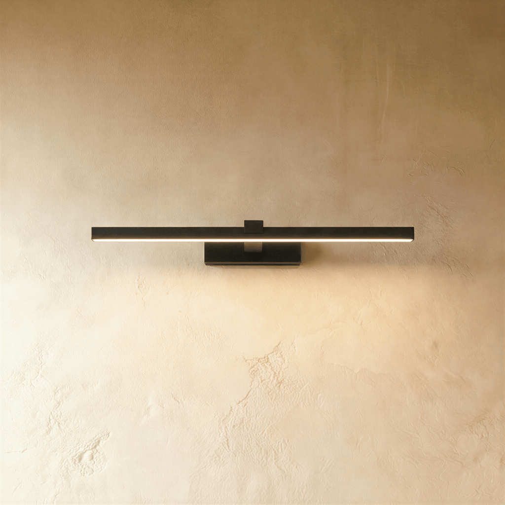 Clérachic slim black linear wall light, 39.5 cm, glowing warm along its diffuser on a textured limewash wall.