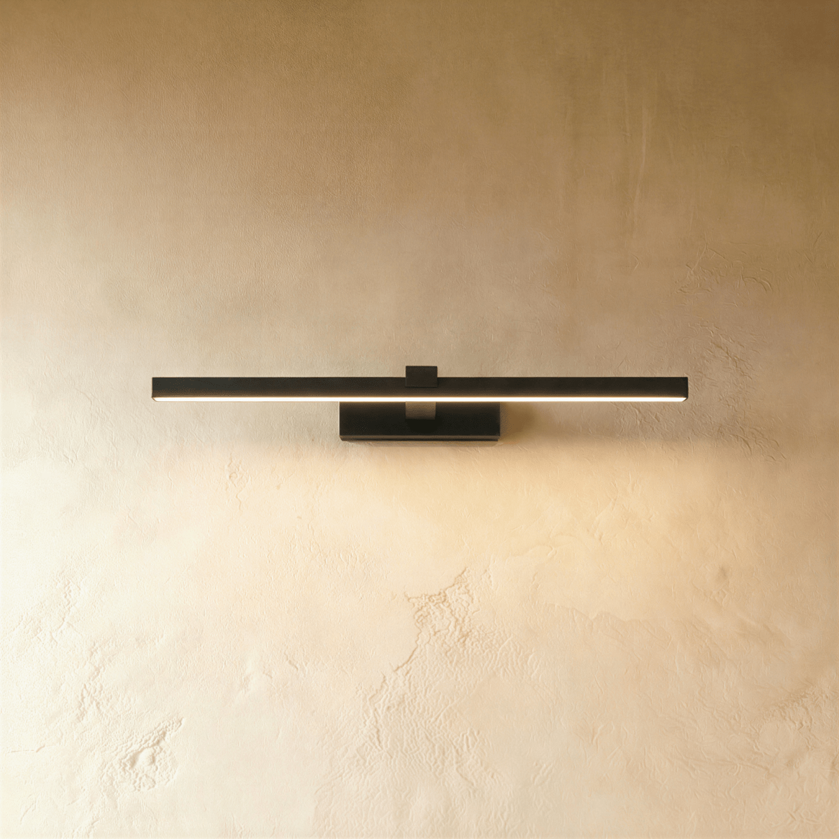 Clérachic slim black linear wall light, 39.5 cm, glowing warm along its diffuser on a textured limewash wall.