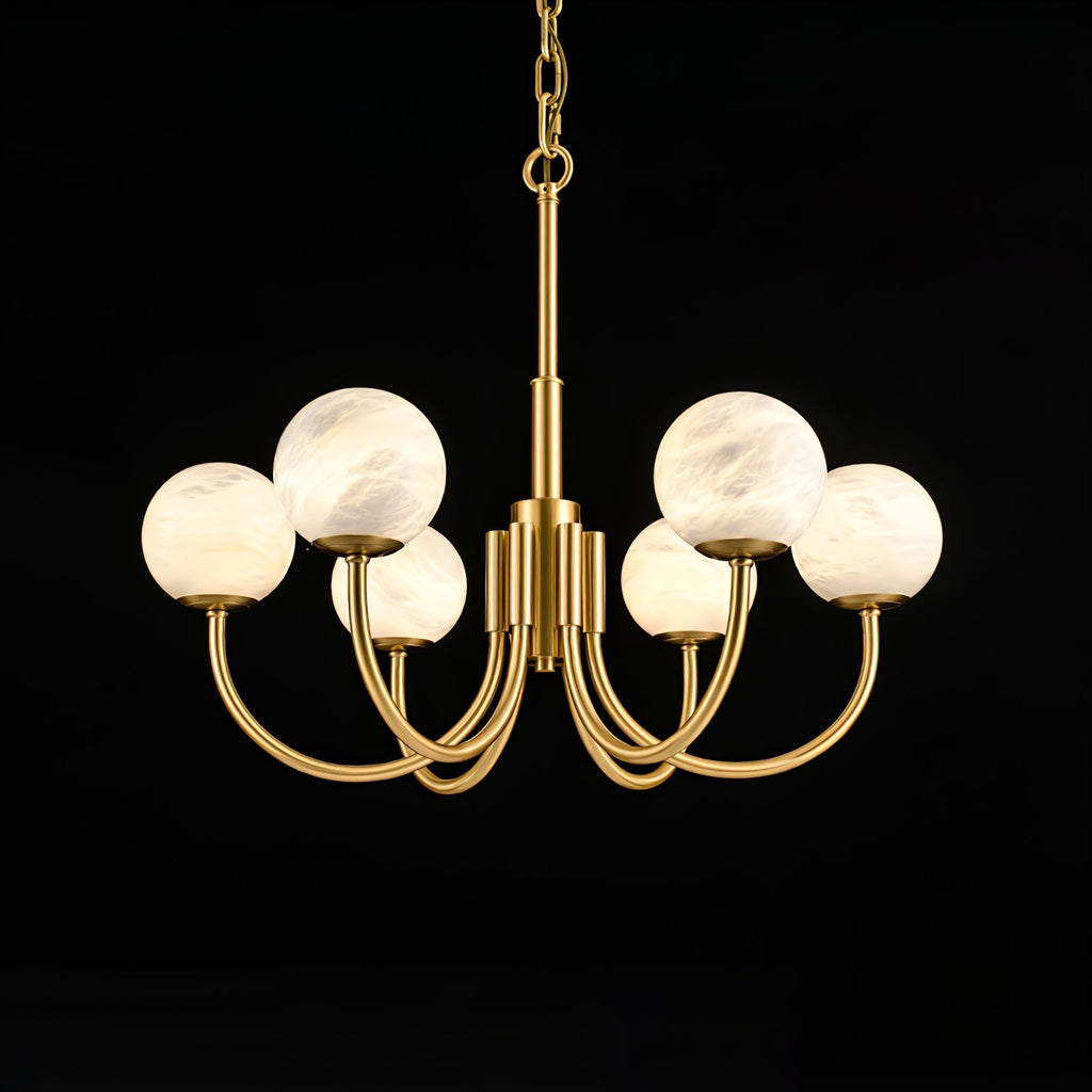 Clérachic alabaster globe chandelier lit on black, warm light held inside each stone sphere.