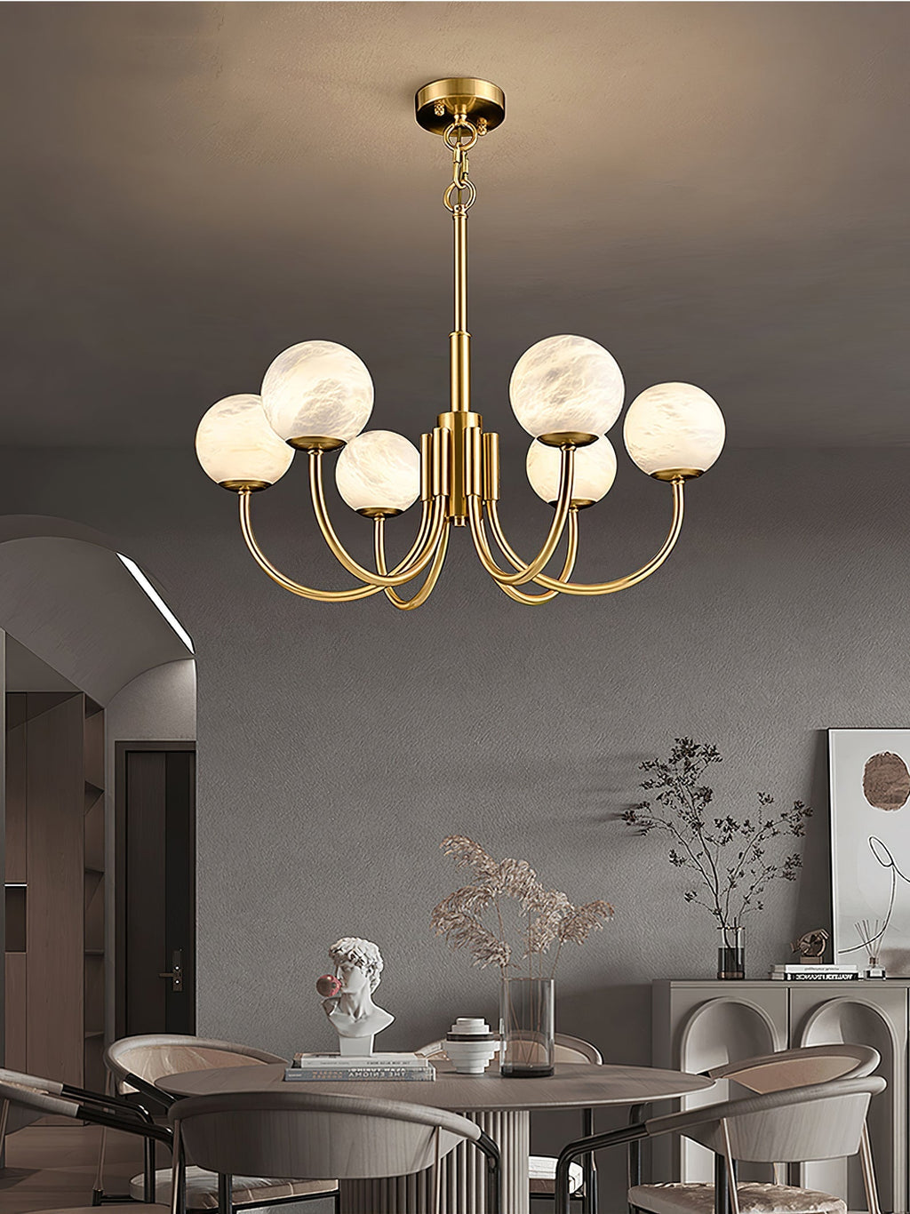 Clérachic globe chandelier above a dining table in an arched room with upholstered chairs.