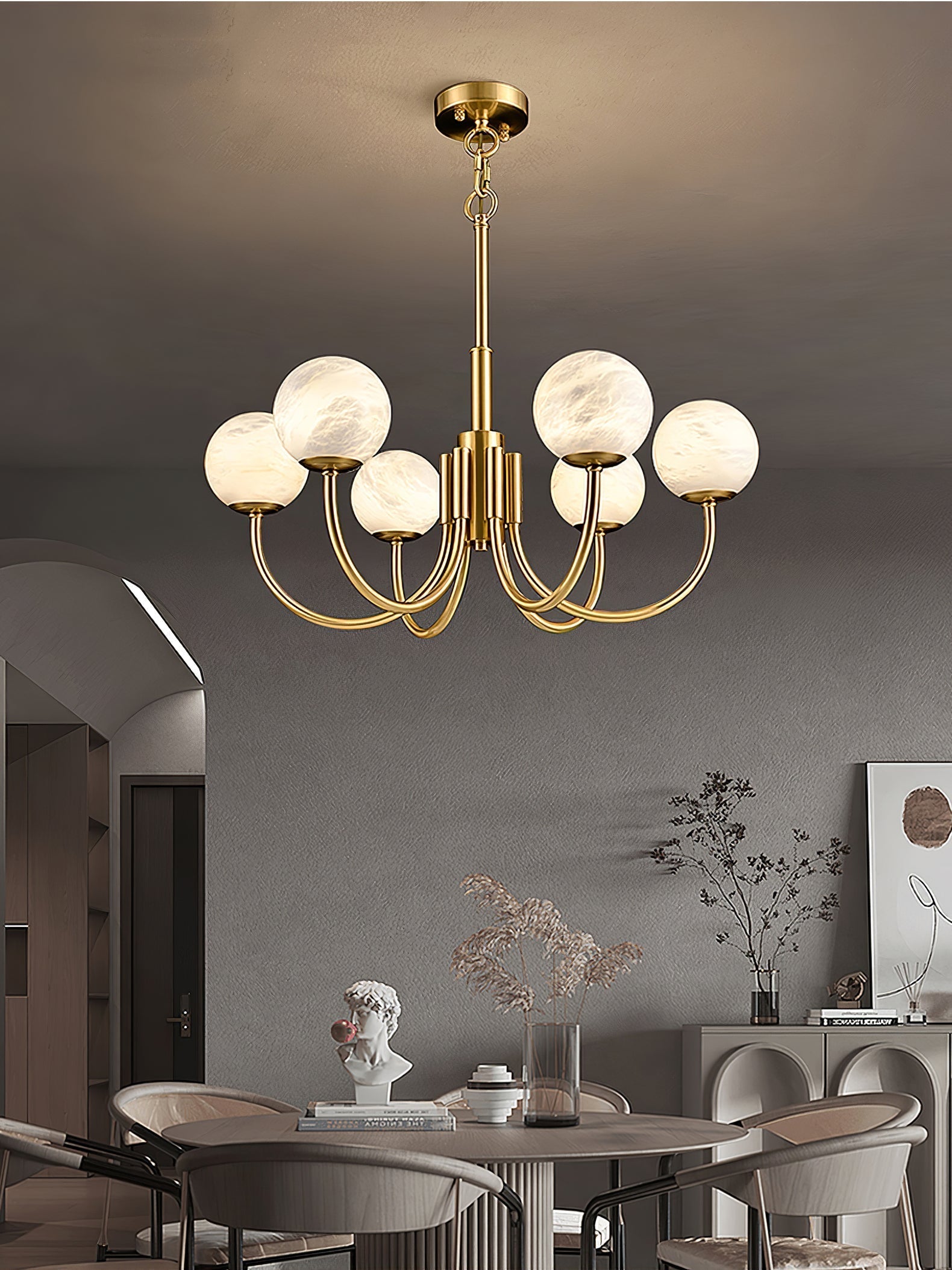 Clérachic globe chandelier above a dining table in an arched room with upholstered chairs.