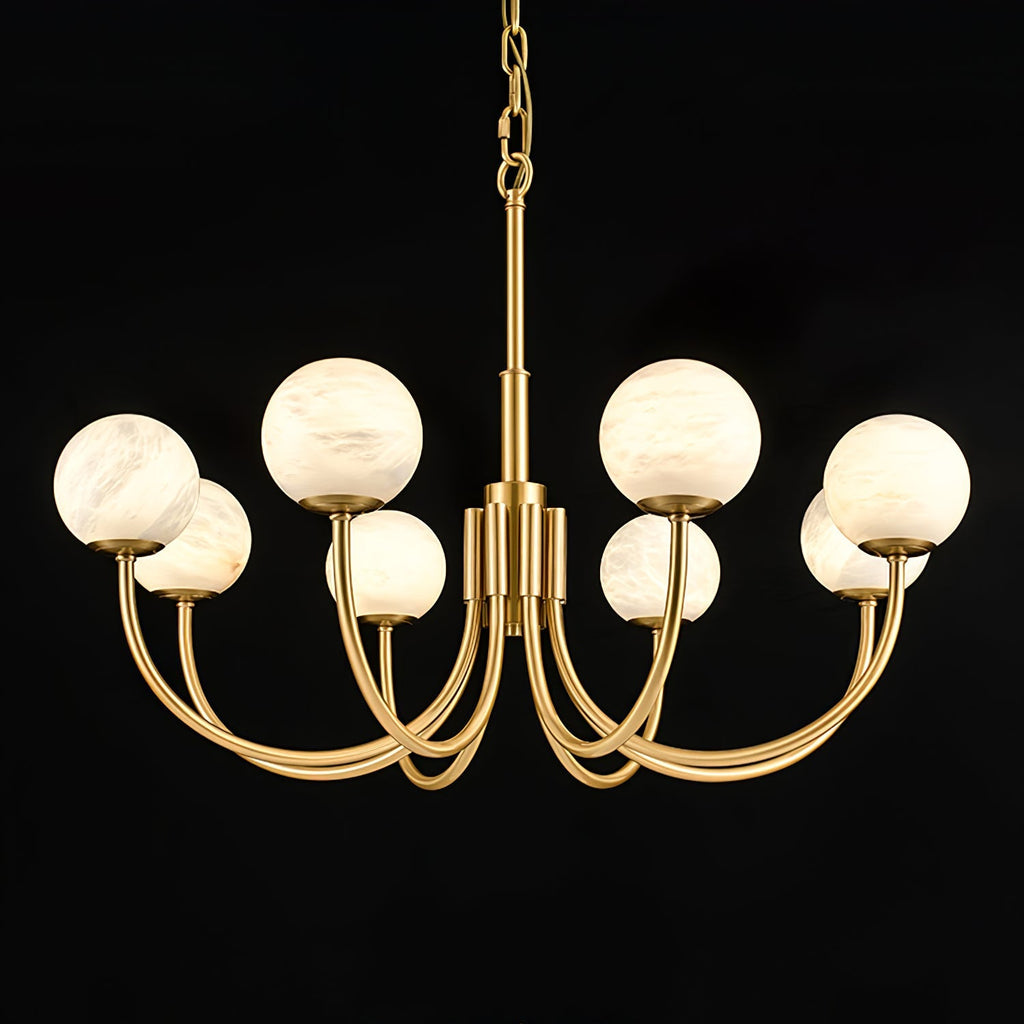 The Clérachic globe chandelier angled on black, showing the sweep of each brass arm.