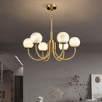 The Clérachic globe chandelier above a dining setting in a softly arched, art-hung room.