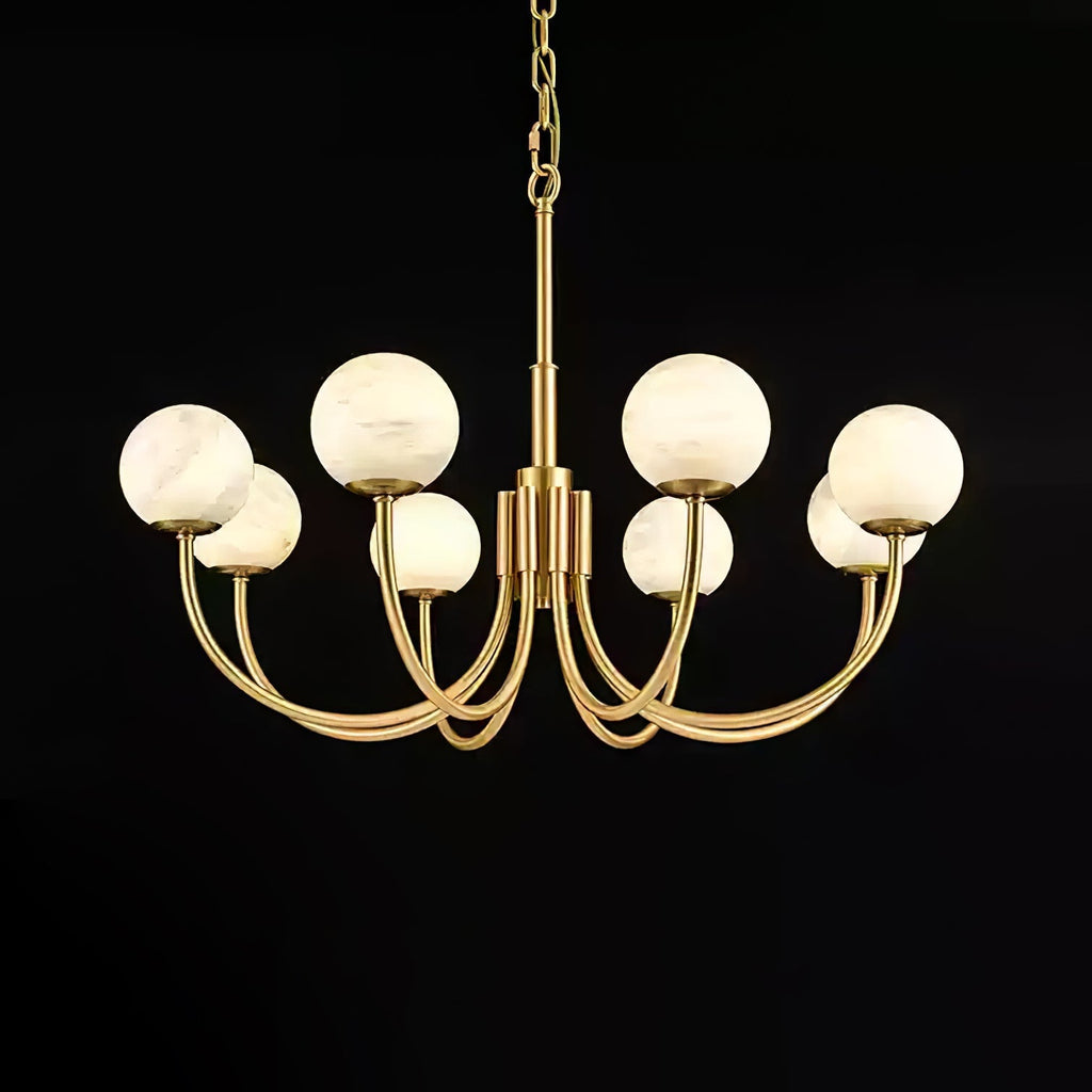 Clérachic globe chandelier lit on black, each alabaster sphere reading warm against the dark.