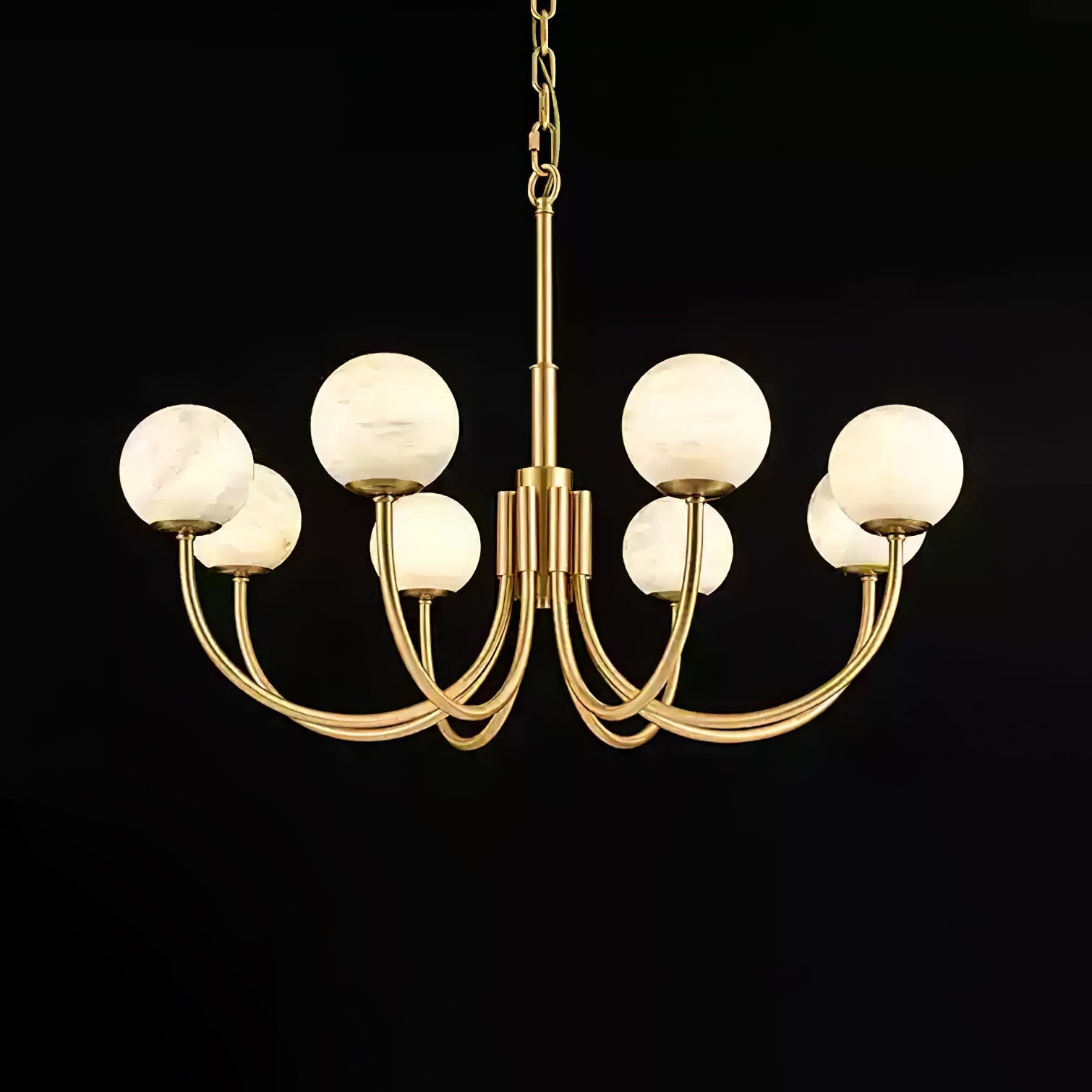 Clérachic globe chandelier lit on black, each alabaster sphere reading warm against the dark.