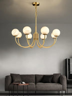 Clérachic globe chandelier above a dark grey sofa and low side table in a modern living room.