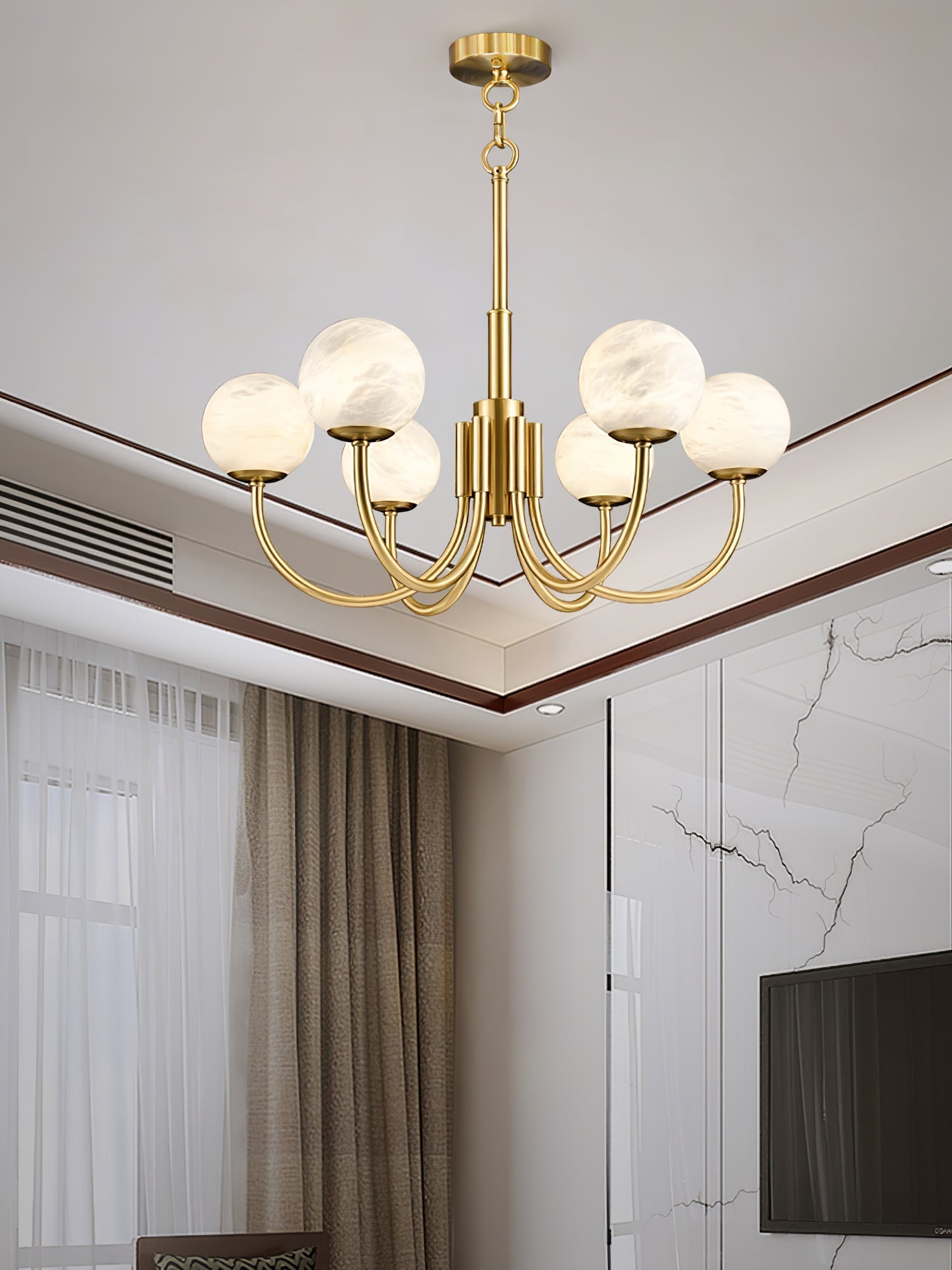 Clérachic globe chandelier in a living room with marble panelling and full-length curtains.