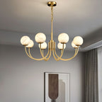 Clérachic globe chandelier lit in a pale room with drawn curtains and a framed print behind.