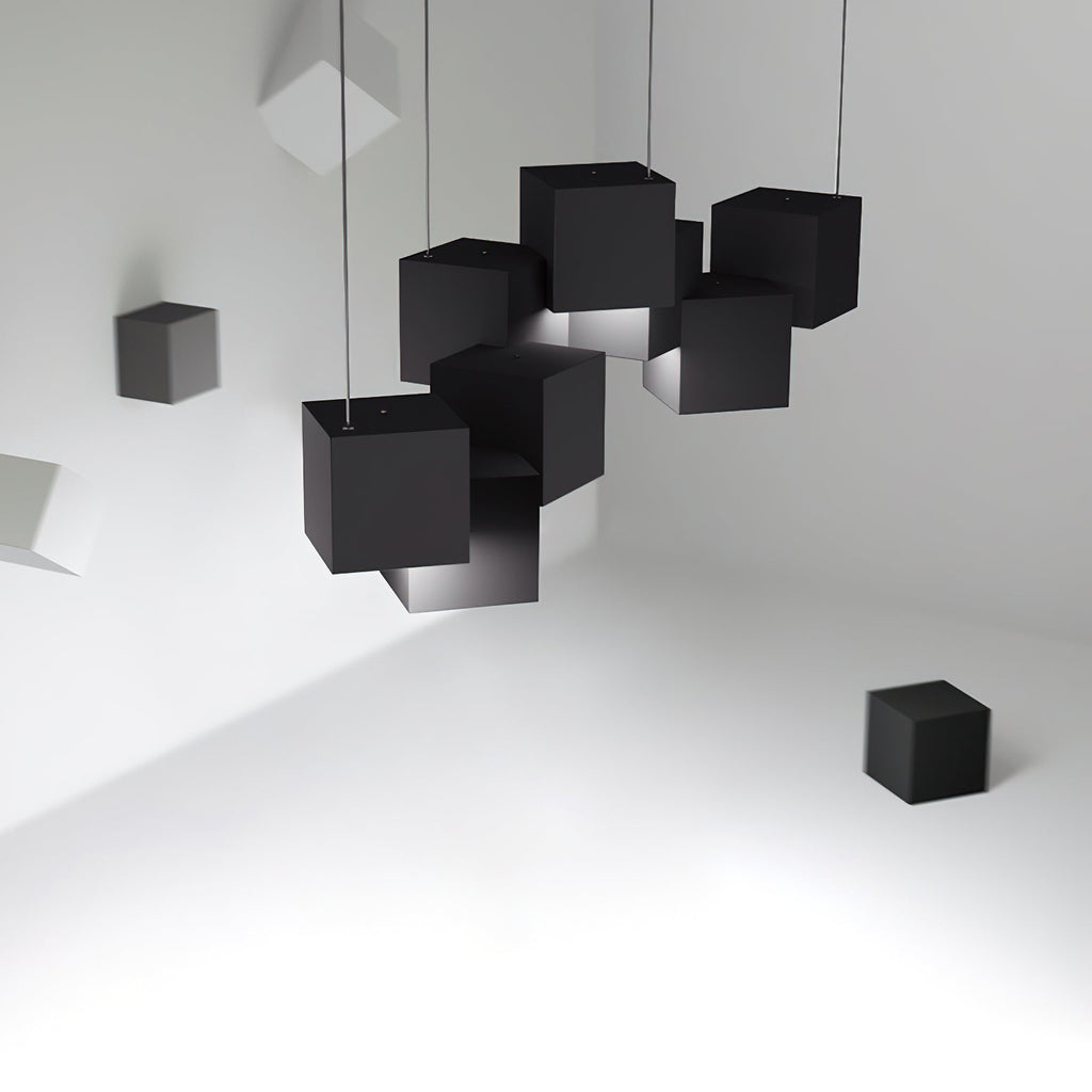 Cluster of black Clérachic cube lights hung at tilted angles in a white room, with loose black cubes on the walls and floor.