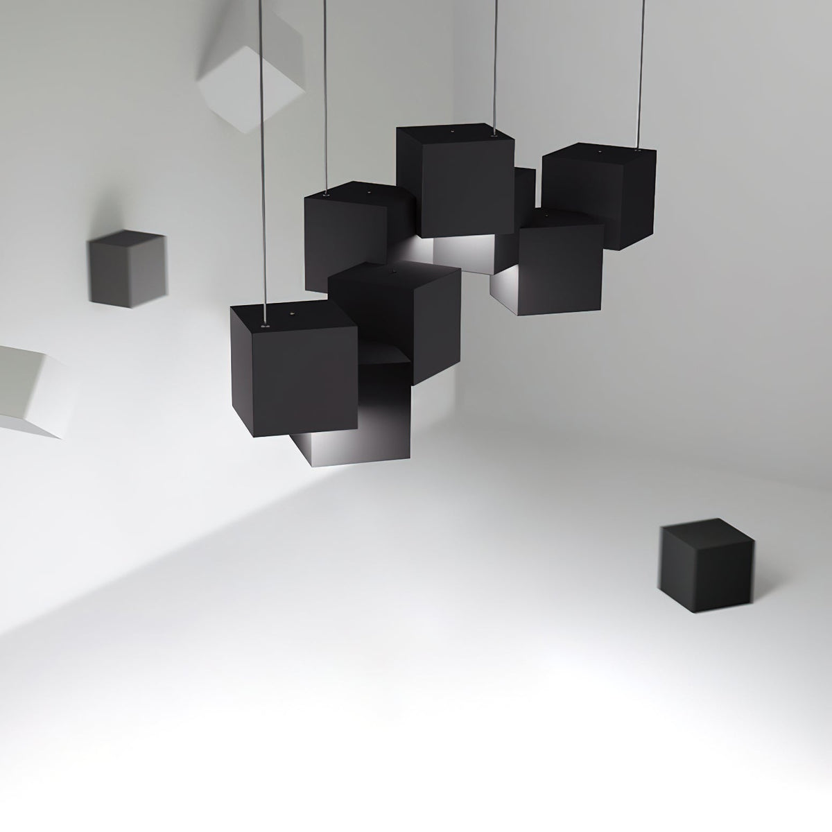 Cluster of black Clérachic cube lights hung at tilted angles in a white room, with loose black cubes on the walls and floor.
