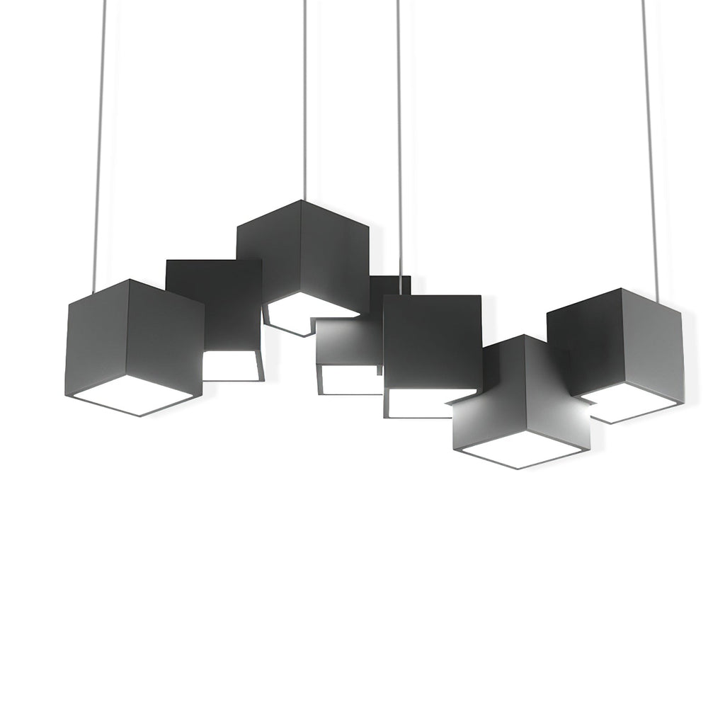 A Clérachic black cube chandelier on a plain white backdrop, the cubes at varied tilts with a lit opening on each underside.
