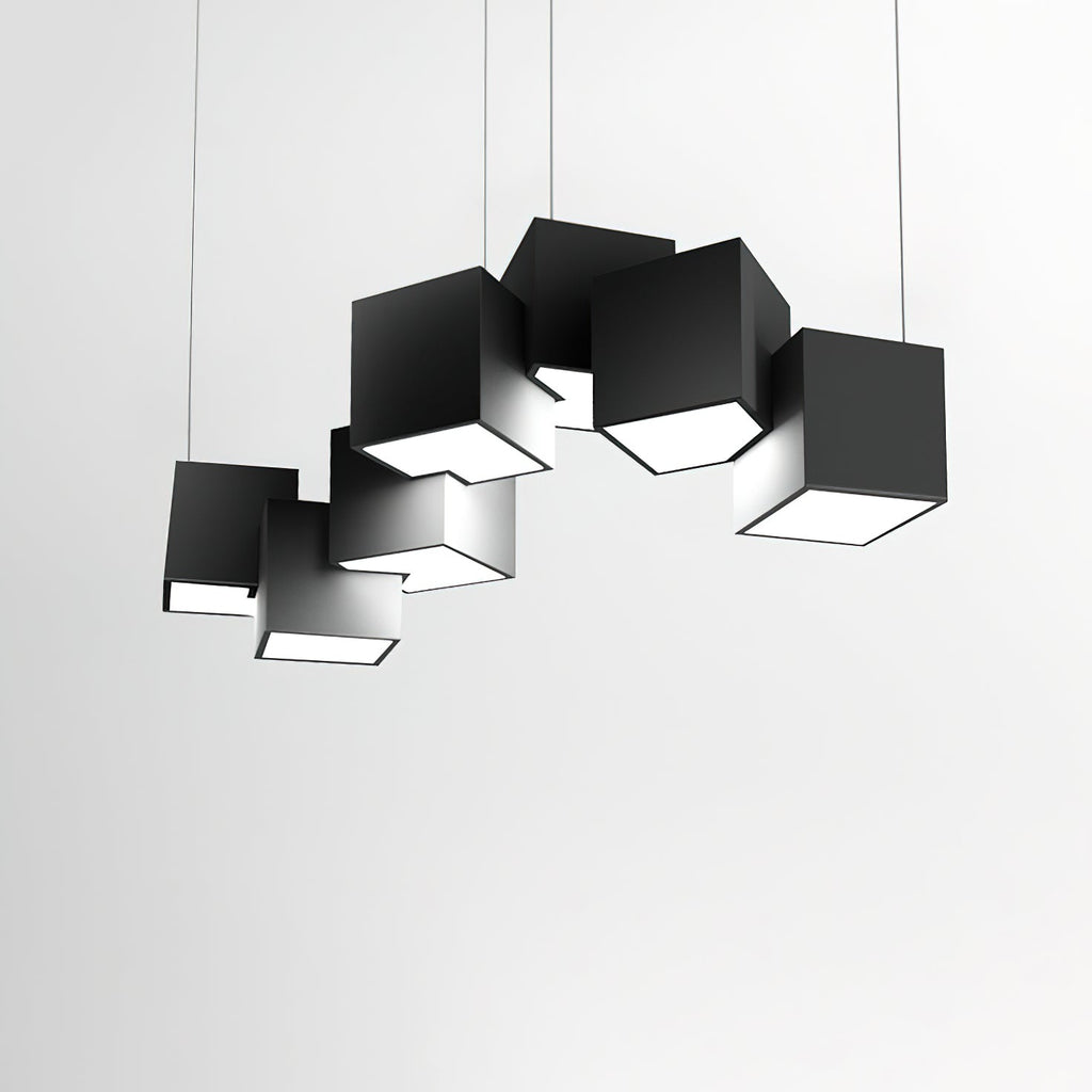 A Clérachic black cube chandelier against a pale grey wall, its tilted cubes casting soft shadows on one another.