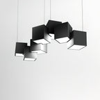 A Clérachic black cube chandelier against a pale grey wall, its tilted cubes casting soft shadows on one another.