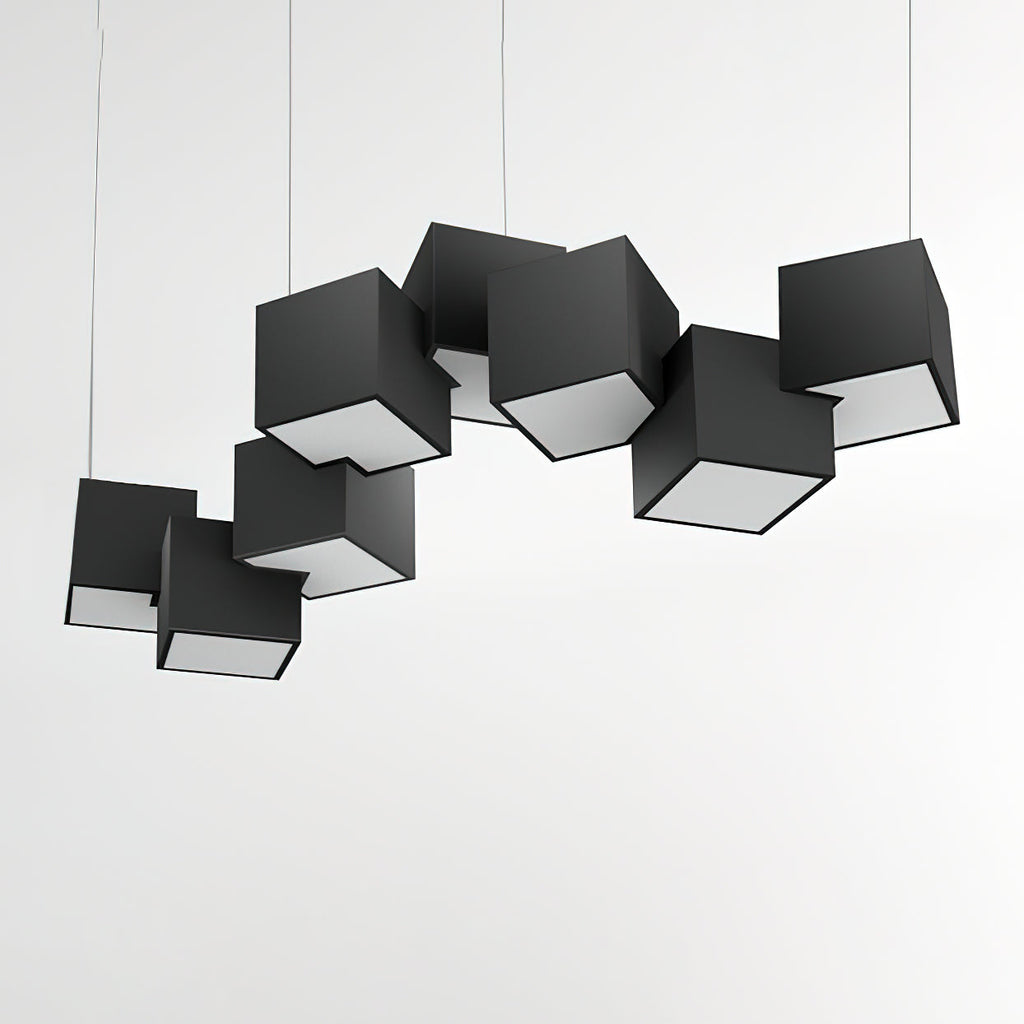A Clérachic chandelier of black cubes over a pale wall, the tilted cubes showing their white lit undersides.