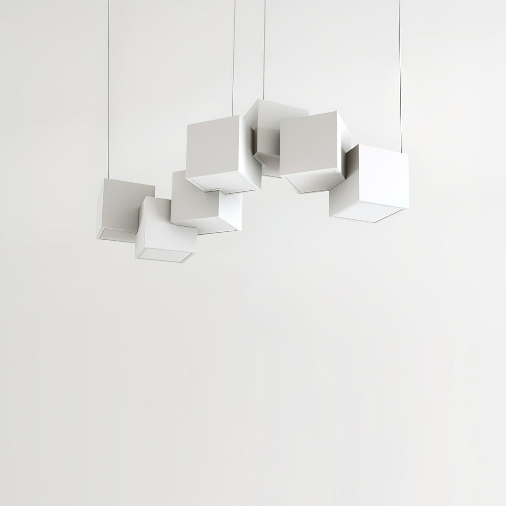 Clérachic chandelier of white cubes against a pale wall, hung at different heights and angles on four fine wires.