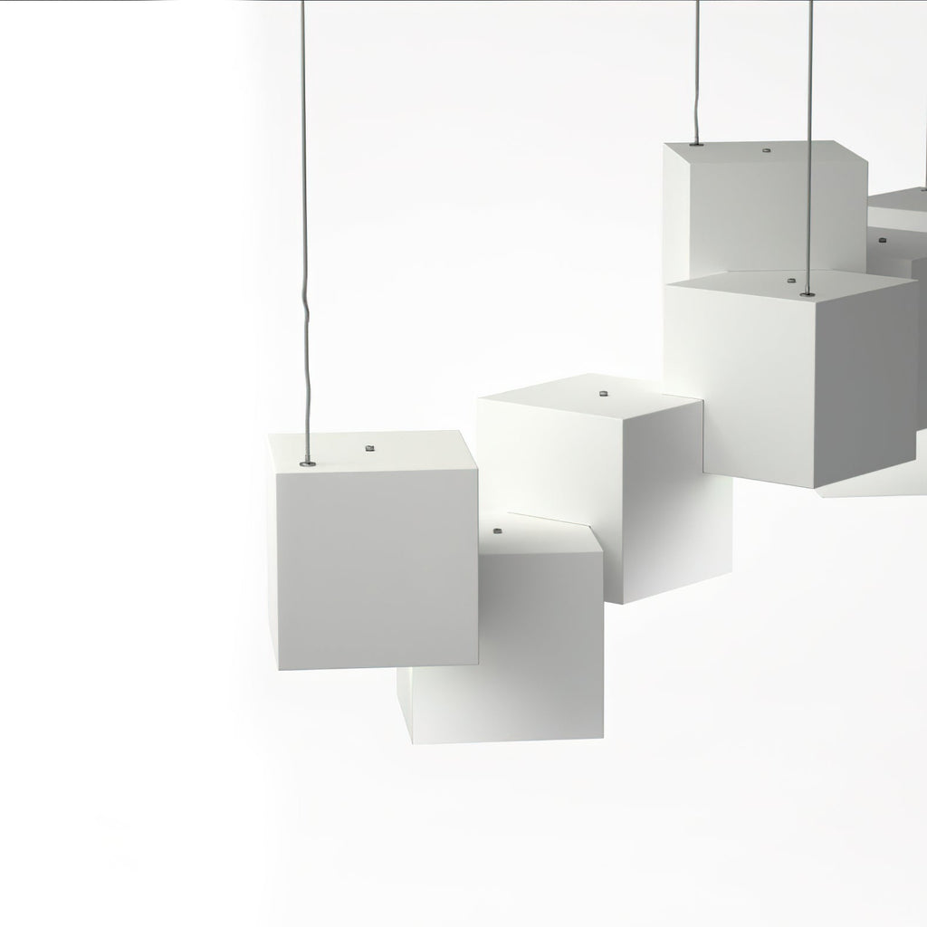 Close view of white Clérachic cube lights, showing the small hanging holes on top of each cube and the thin wires.