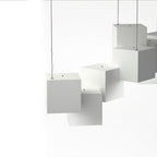 Close view of white Clérachic cube lights, showing the small hanging holes on top of each cube and the thin wires.