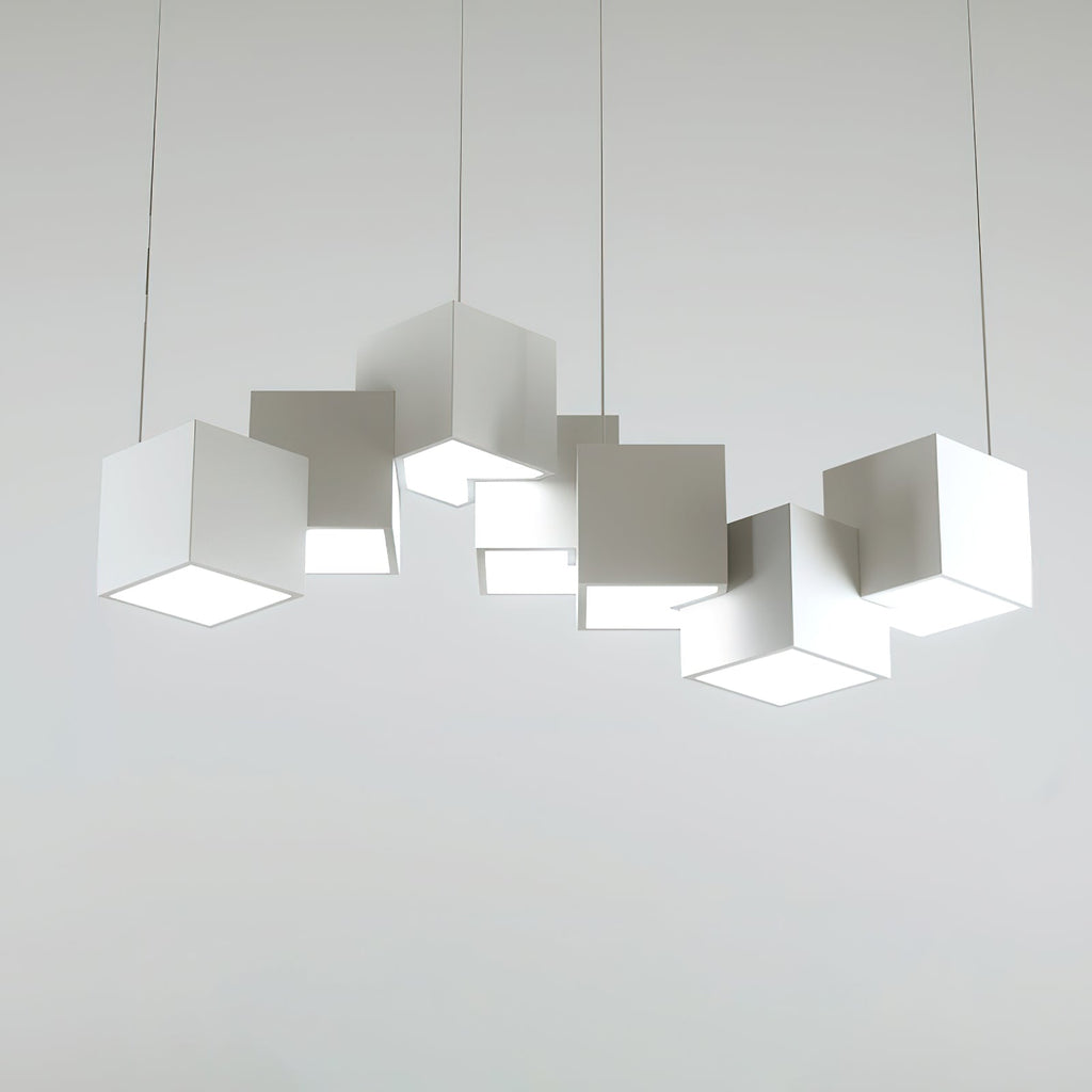 A Clérachic white cube chandelier on a light grey backdrop, the cubes at different tilts with bright undersides.