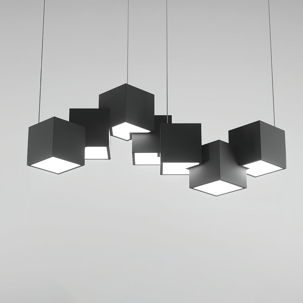 A Clérachic black cube chandelier on a light grey backdrop, shown straight on with the white undersides glowing.