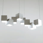 Clérachic white cube chandelier on a light grey backdrop, with its offset cubes and thin wires clearly visible.