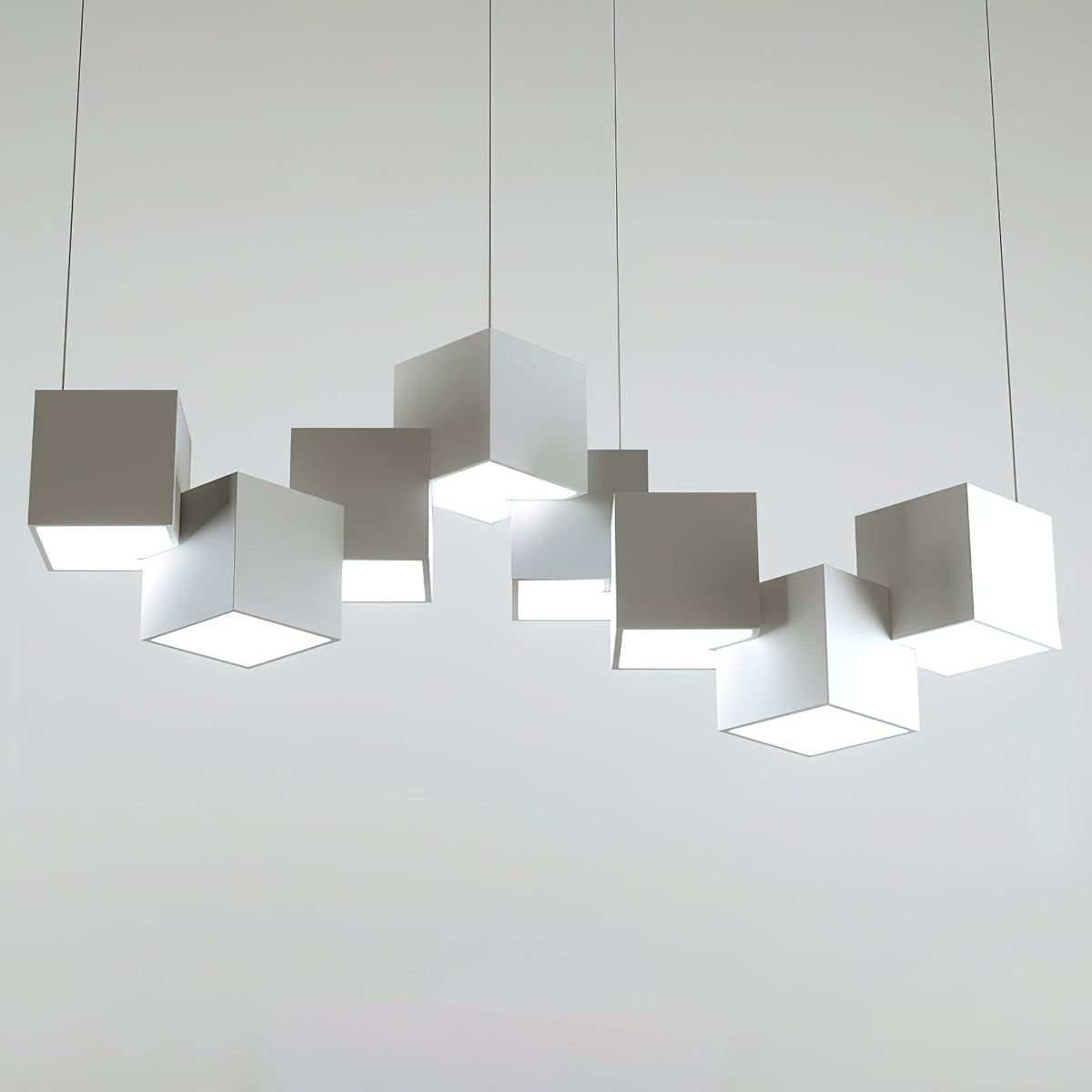 Clérachic white cube chandelier on a light grey backdrop, with its offset cubes and thin wires clearly visible.