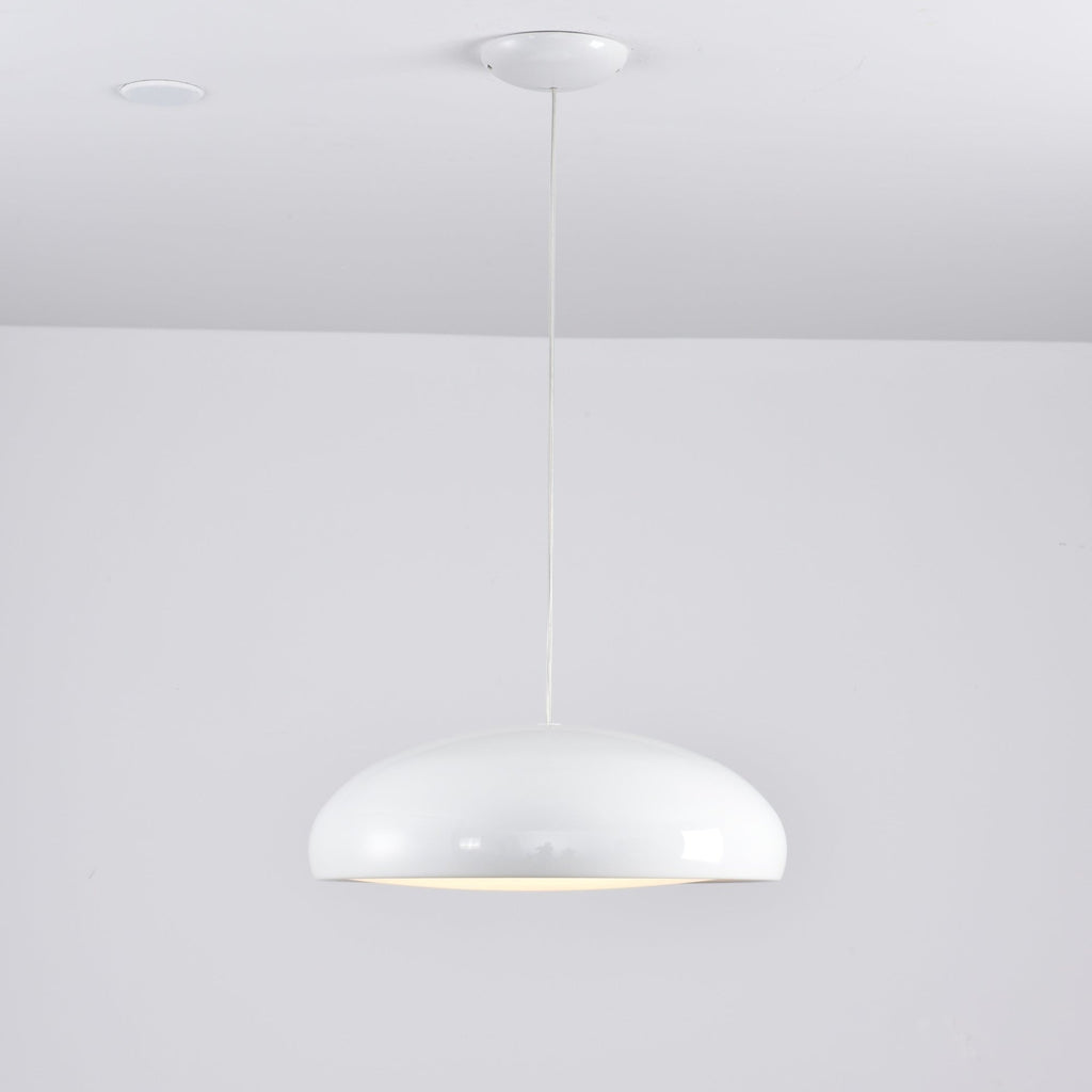 Small white Clérachic dome pendant on a long cable, with a white ceiling canopy and a soft glow at its base.