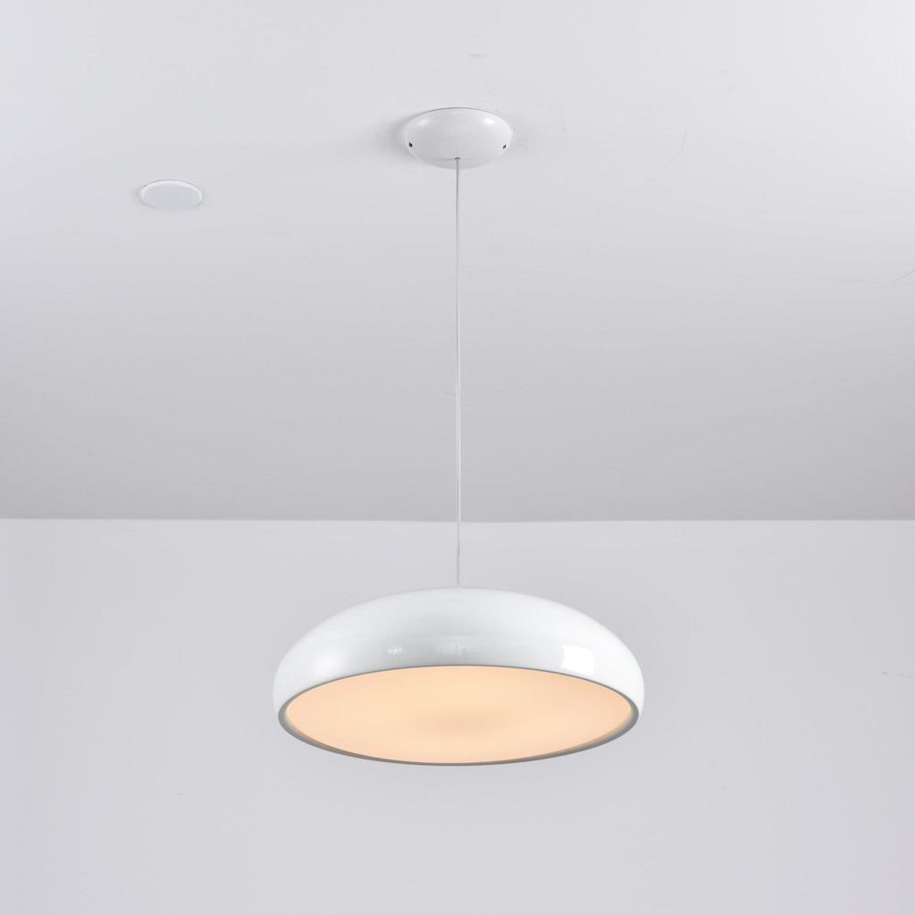 White Clérachic dome pendant tilted to show its warm, lit diffuser, hung from a white round canopy.