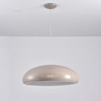 Warm grey Clérachic dome pendant viewed slightly from below, its unlit grey diffuser visible inside the rim.