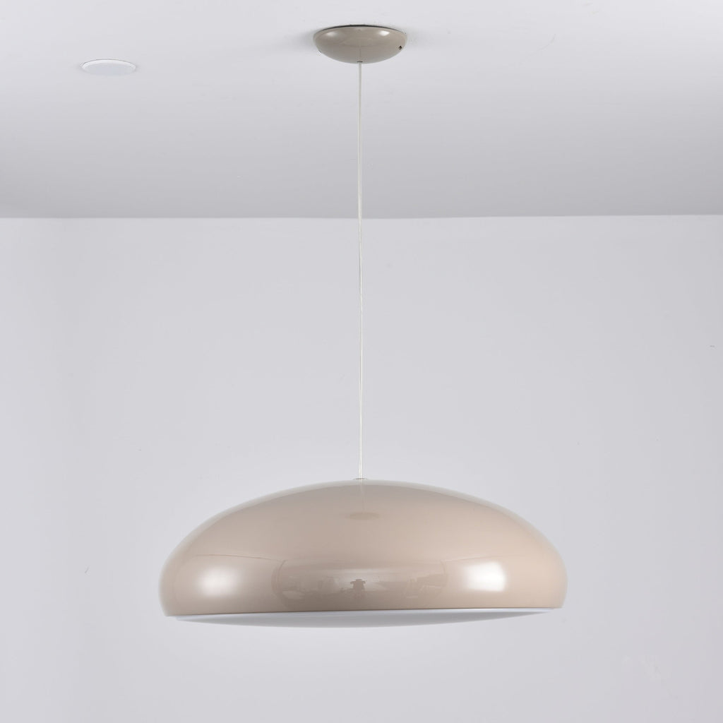 A warm grey Clérachic dome pendant from a low angle, with a smooth, glossy shell and a pale underside.