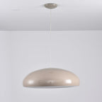 A warm grey Clérachic dome pendant from a low angle, with a smooth, glossy shell and a pale underside.