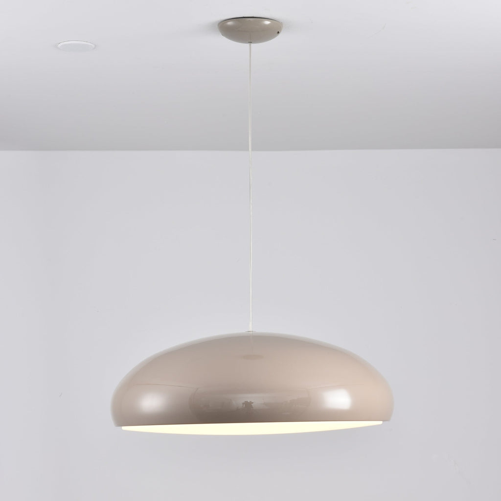 Warm grey Clérachic dome pendant with a thin bright line of light under the rim, shown against a white wall.
