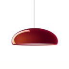 Glossy dark-red Clérachic dome pendant on a white background, its bright reflection curving along one side of the shell.