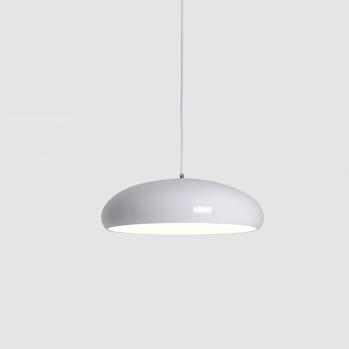 White Clérachic dome pendant on a light grey backdrop, with a softly glowing underside and a slim white cable.
