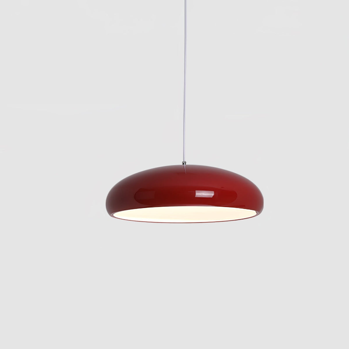 Dark-red Clérachic dome pendant on a grey backdrop, centred and lit, with a glowing white underside.