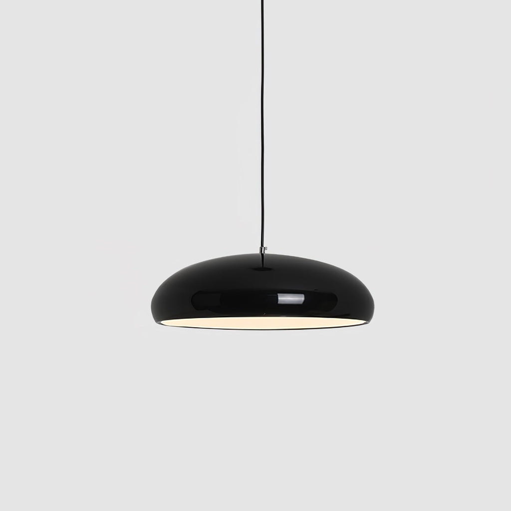 A black Clérachic dome pendant on a grey backdrop, hung from a thin black cable with its inner light glowing.