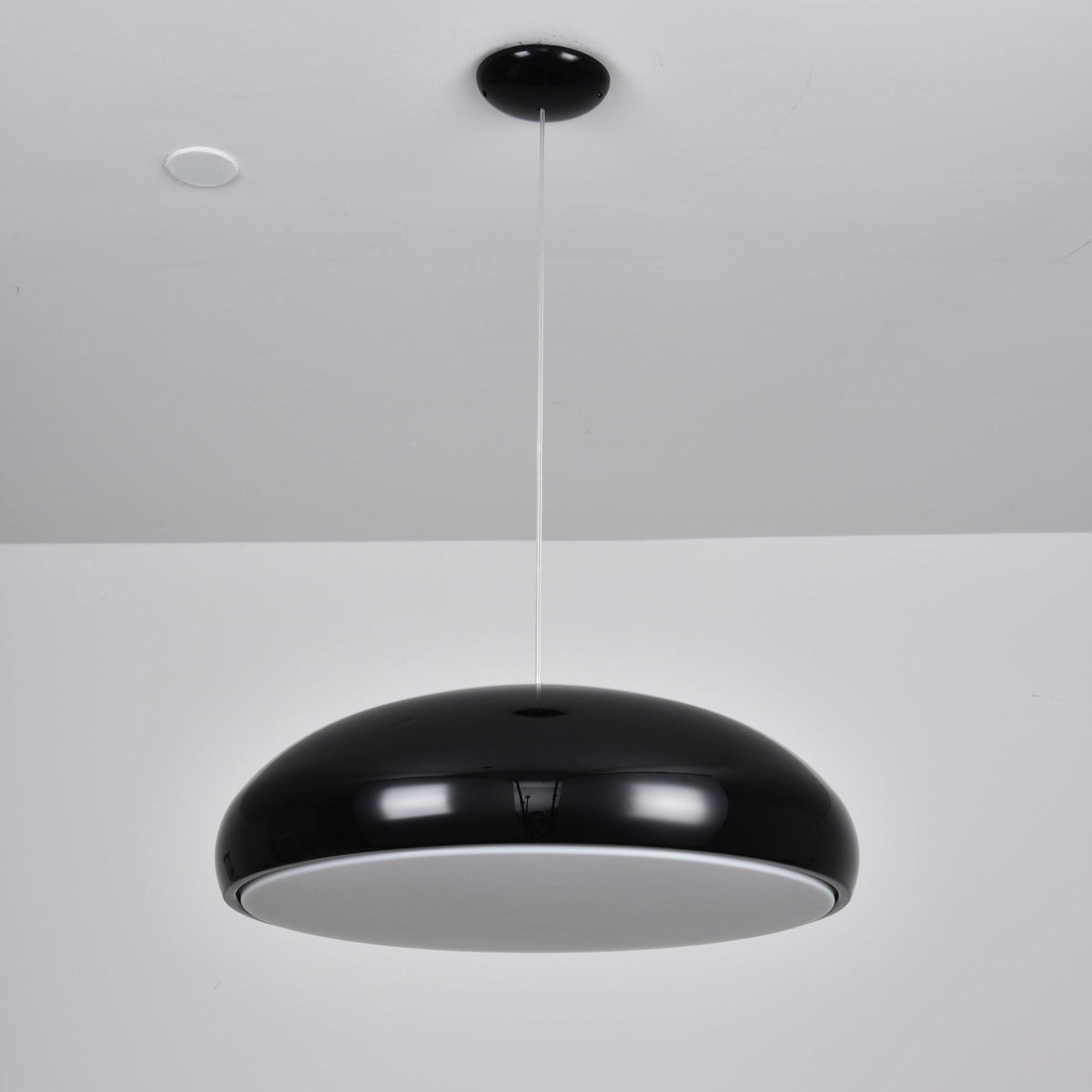 Black Clérachic dome pendant seen from below, hung from a black ceiling canopy, showing its grey inner diffuser unlit.