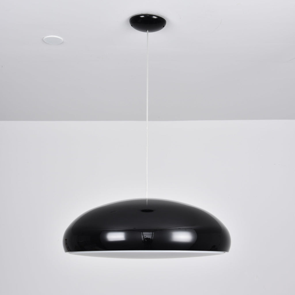 A black Clérachic dome pendant with a thin white rim of light below the shell, hung from a black ceiling canopy.