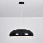 Black Clérachic dome pendant with a faint warm glow at its lower edge, hanging from a black ceiling canopy.