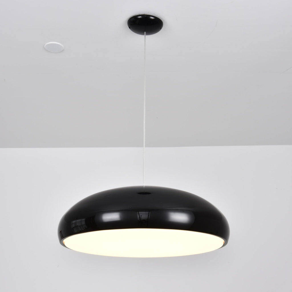 Black Clérachic dome pendant lit from below, with a bright warm diffuser visible under the shell.