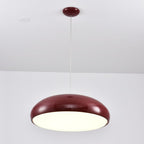 Dark-red Clérachic dome pendant lit from below, with a bright diffuser disc and a matching dark-red ceiling canopy.