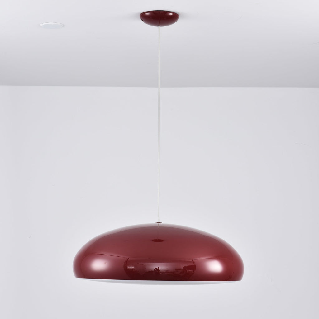 Dark-red Clérachic dome pendant on a long white cable, the shell reflecting the room, with a small red canopy above.