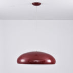 Dark-red Clérachic dome pendant on a long white cable, the shell reflecting the room, with a small red canopy above.