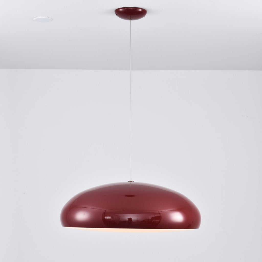 Dark-red Clérachic dome pendant against a pale wall, its glossy shell mirroring the room and its canopy matching the colour.