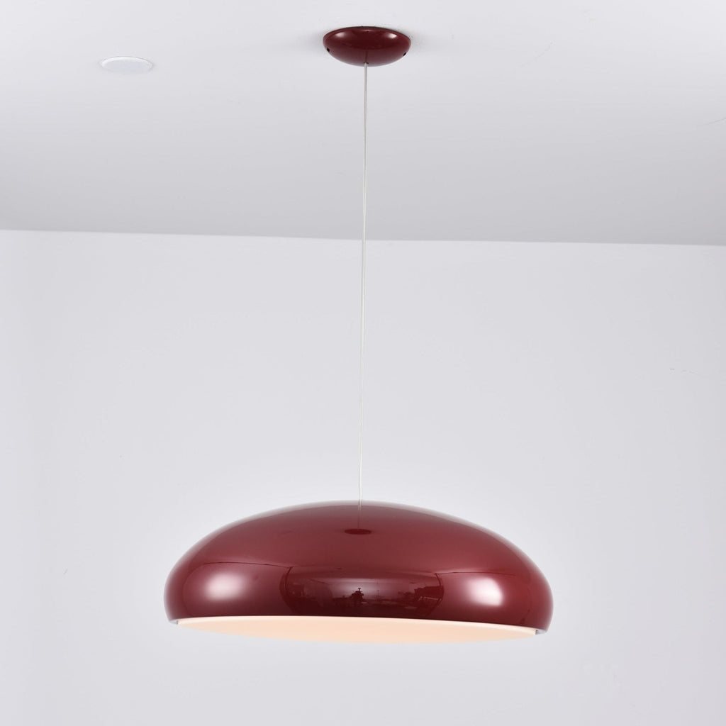 Dark-red Clérachic dome pendant glowing a soft peach at its underside, hung from a red canopy by a thin cable.